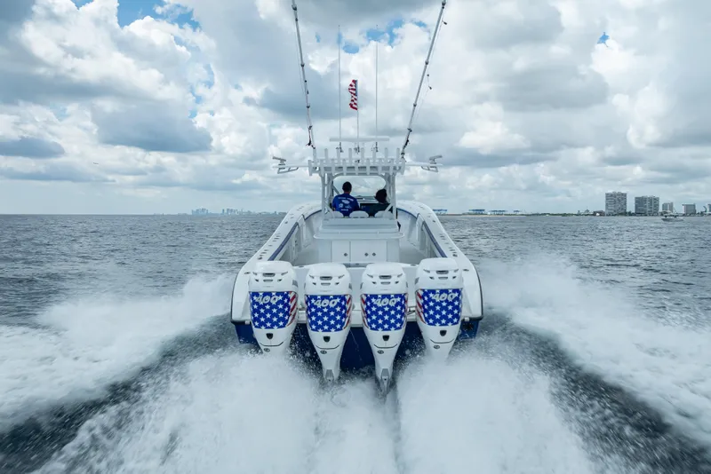 Slide: The Image of 2023 Yellowfin 39 Offshore boat speeding on open water under cloudy sky. - 19