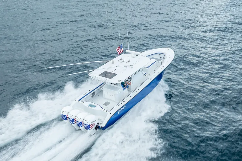 Slide: The Image of 2023 Yellowfin 39 Offshore boat cruising on open water, featuring quad engines. - 21