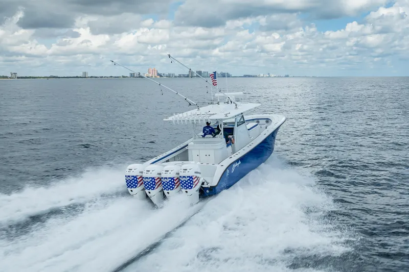 Slide: The Image of 2023 Yellowfin 39 Offshore boat cruising on open water under cloudy sky. - 23