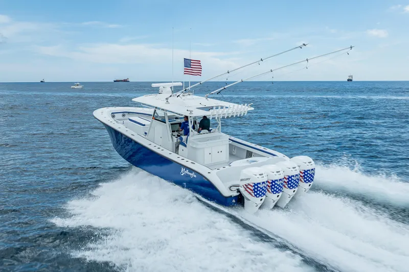 Slide: The Image of 2023 Yellowfin 39 Offshore boat cruising on open sea with American flag. - 24
