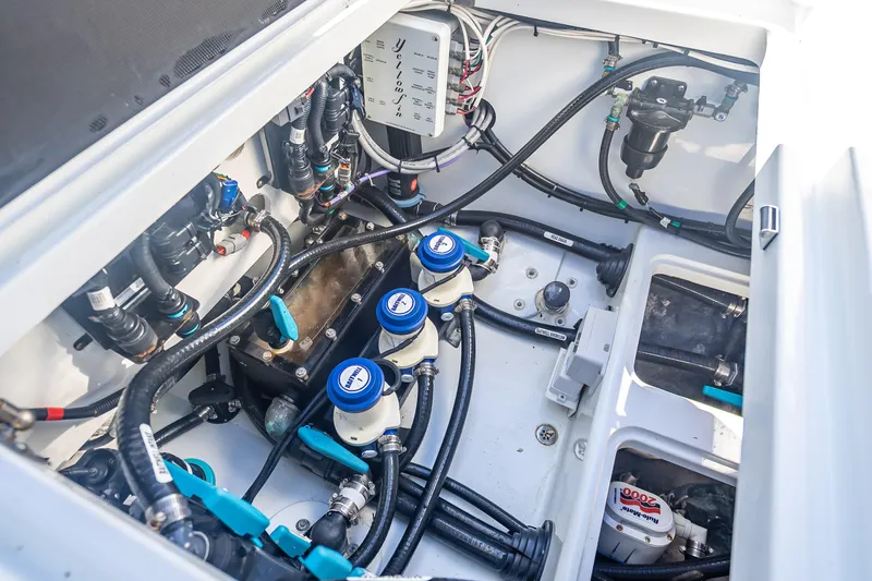 Slide: The Image of Engine compartment of 2023 Yellowfin 39 Offshore boat, showcasing intricate wiring and components. - 27