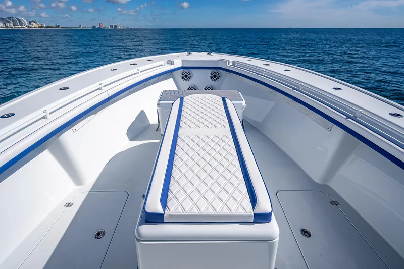 Slide: The Image of 2023 Yellowfin 39 Offshore boat interior with cushioned seating on open water. - 32