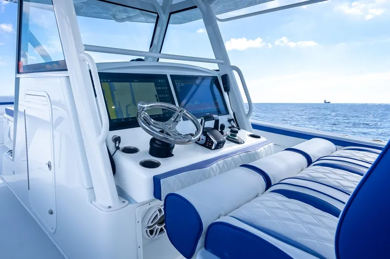 Slide: The Image of 2023 Yellowfin 39 Offshore boat cockpit with modern navigation system and ocean view. - 39