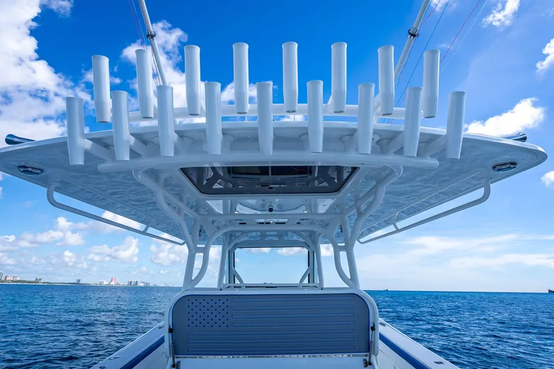 Slide: The Image of 2023 Yellowfin 39 Offshore boat with rod holders, ocean view, and blue sky. - 54