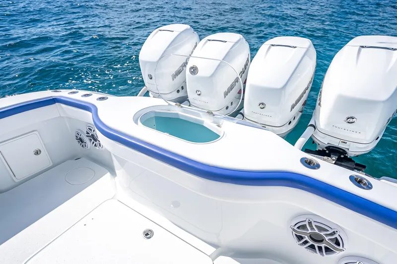 Slide: The Image of 2023 Yellowfin 39 Offshore boat with four powerful outboard engines on blue ocean water. - 56