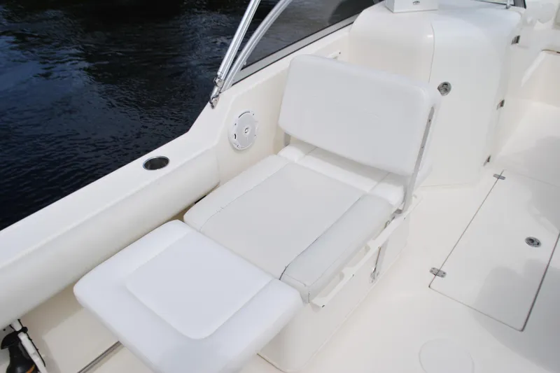 Slide: The Image of 2015 Cobia 220 Dual Console boat interior with white seating. - 12