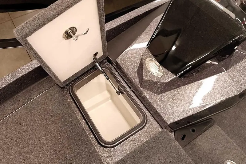 Slide: The Image of 2025 Ranger Z185 boat storage compartment with open lid and sleek design. - 11
