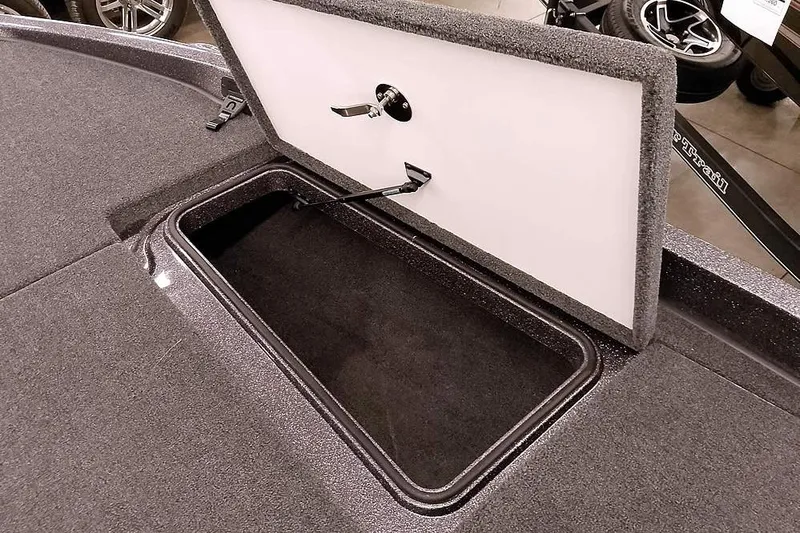 Slide: The Image of Open storage compartment on 2025 Ranger Z185 boat deck. - 12