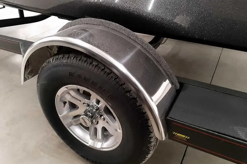 Slide: The Image of 2025 Ranger Z185 trailer wheel with silver fender and Karrigan tire on concrete floor. - 5