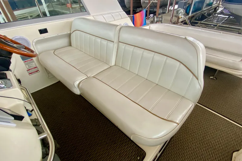 Slide: The Image of 1997 Sea Ray 330 Sundancer interior with white leather seating and steering wheel. - 12