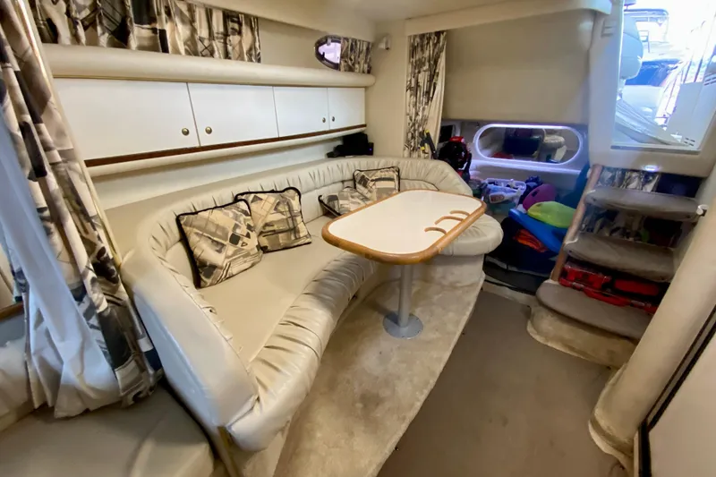 Slide: The Image of Interior of 1997 Sea Ray 330 Sundancer with cozy seating and table. - 19