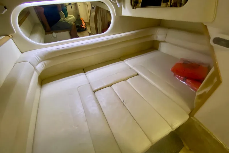 Slide: The Image of 1997 Sea Ray 330 Sundancer cabin interior with beige seating and life jackets. - 22