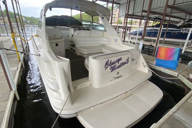 Slide: The Image of 1997 Sea Ray 330 Sundancer docked, featuring spacious seating and sleek design. - 5