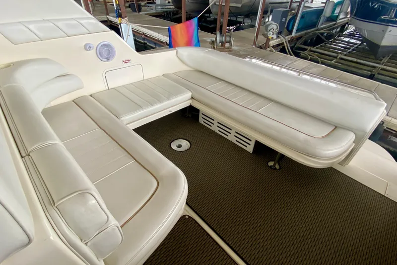 Slide: The Image of 1997 Sea Ray 330 Sundancer interior with white leather seating and carpeted flooring. - 7
