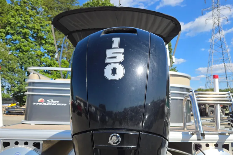 Slide: The Image of 2023 Sun Tracker Party Barge 22 RF DLX with 150 HP engine, outdoor setting. - 13