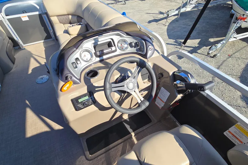 Slide: The Image of 2023 Sun Tracker Party Barge 22 RF DLX steering console with gauges and controls. - 15