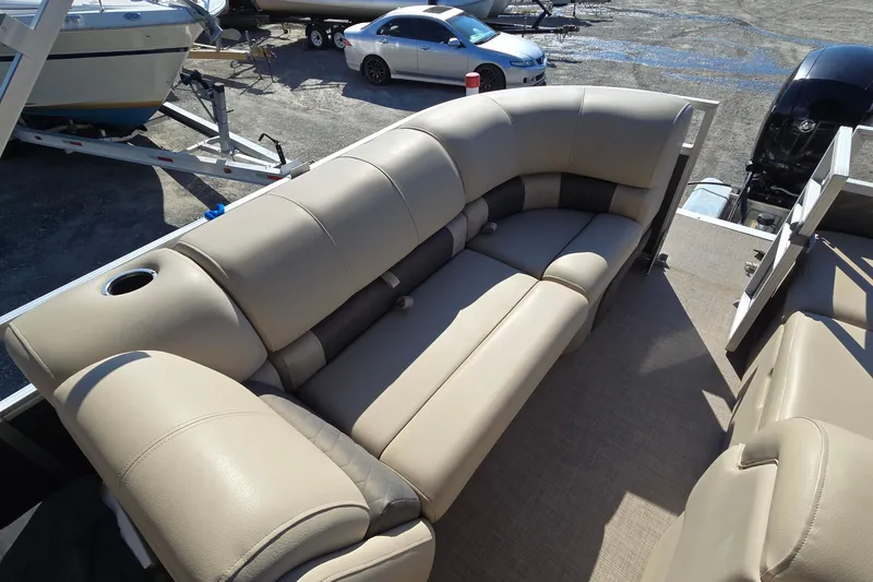 Slide: The Image of 2023 Sun Tracker Party Barge 22 RF DLX with beige seating and cup holder. - 22