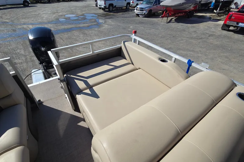 Slide: The Image of 2023 Sun Tracker Party Barge 22 RF DLX with beige seating and outboard motor. - 23