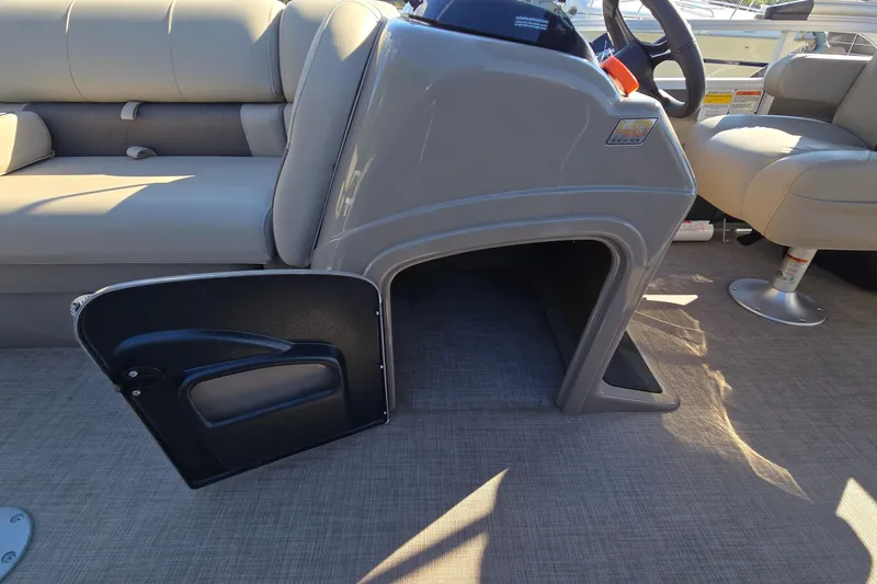 Slide: The Image of 2023 Sun Tracker Party Barge 22 RF DLX interior with open storage compartment. - 24