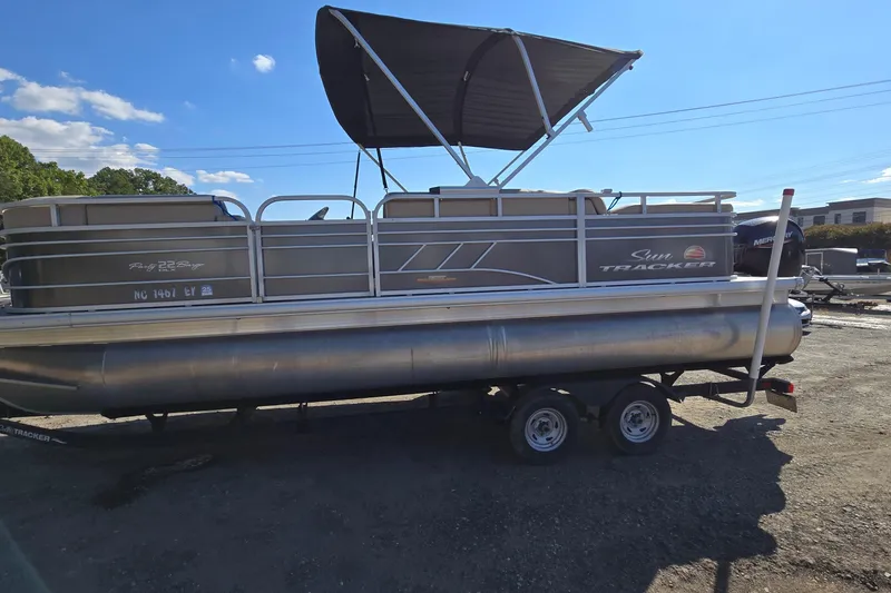 Slide: The Image of 2023 Sun Tracker Party Barge 22 RF DLX pontoon boat with canopy on trailer. - 3