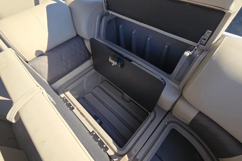 Slide: The Image of 2023 Sun Tracker Party Barge 22 RF DLX storage compartment with open seat cushion. - 33