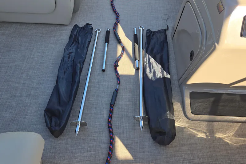 Slide: The Image of 2023 Sun Tracker Party Barge 22 RF DLX boat accessories on deck, including anchors and rope. - 38