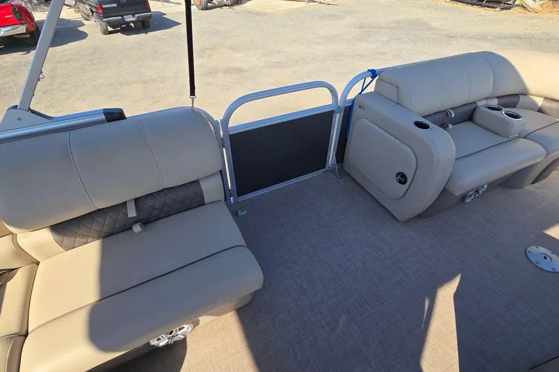 Slide: The Image of 2023 Sun Tracker Party Barge 22 RF DLX interior with beige seating and cup holders. - 39