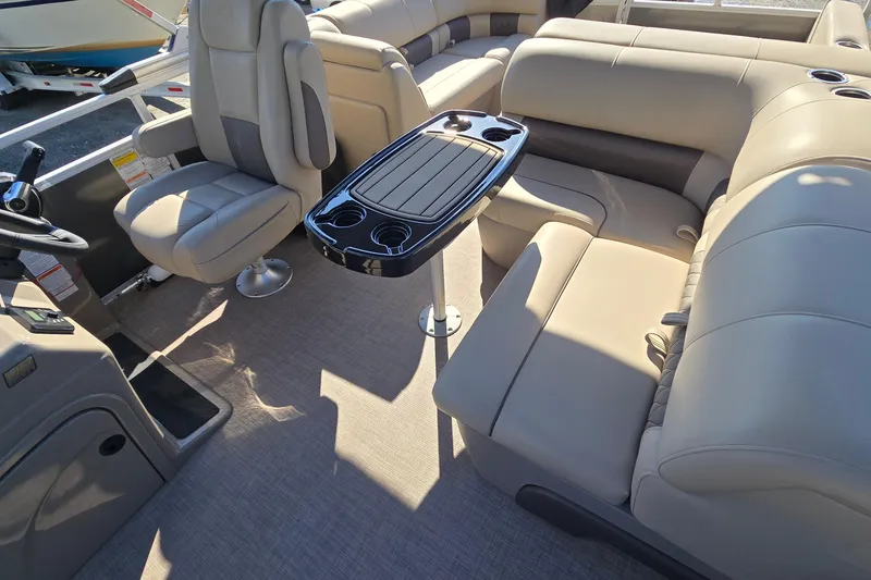 Slide: The Image of 2023 Sun Tracker Party Barge 22 RF DLX interior with plush seating and table. - 40