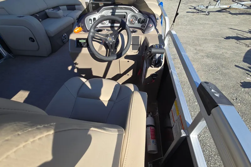Slide: The Image of 2023 Sun Tracker Party Barge 22 RF DLX interior with steering wheel and seating. - 43