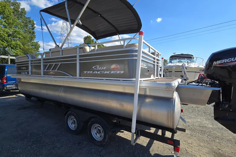 Slide: The Image of 2023 Sun Tracker Party Barge 22 RF DLX pontoon boat on trailer, parked outdoors. - 5