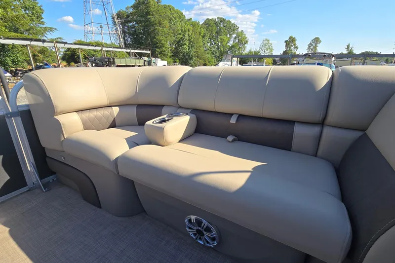 Slide: The Image of 2023 Sun Tracker Party Barge 22 RF DLX interior with plush seating and cup holders. - 62
