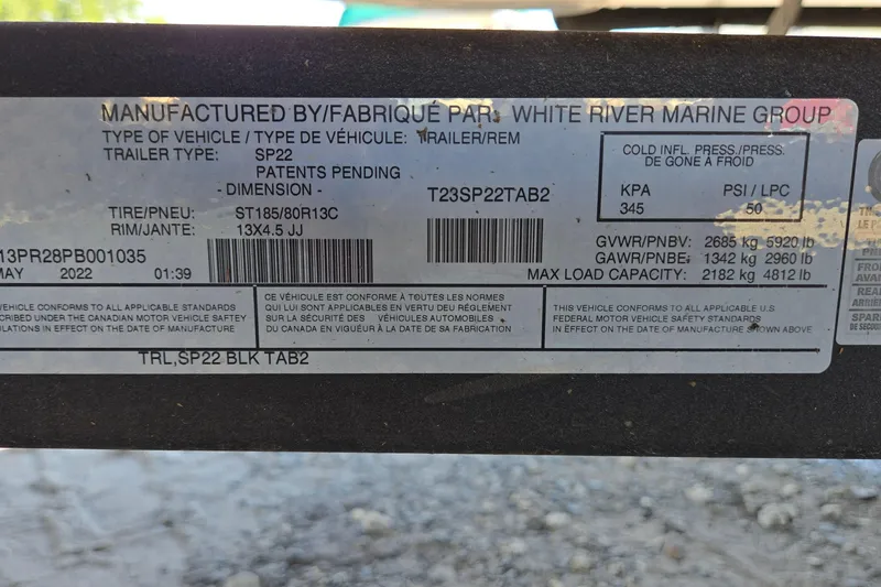 Slide: The Image of 2023 Sun Tracker Party Barge 22 RF DLX trailer label with specifications and safety standards. - 69