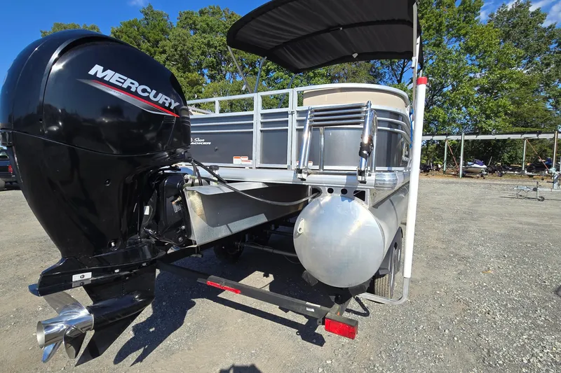 Slide: The Image of 2023 Sun Tracker Party Barge 22 RF DLX with Mercury outboard motor, parked outdoors. - 7
