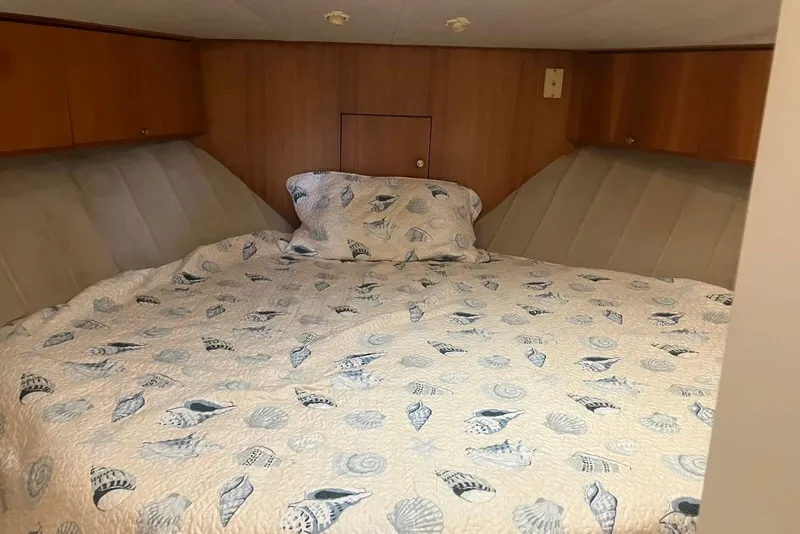 Slide: The Image of 1994 Silverton 41 Aft Cabin kitchen with stove, sink, fridge, and modern backsplash. - 11