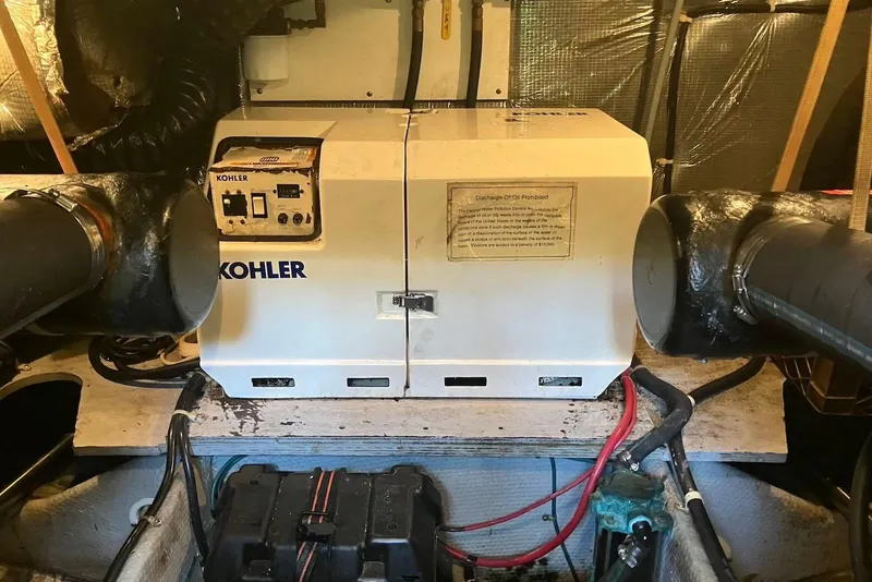 Slide: The Image of 1994 Silverton 41 Aft Cabin interior with wood paneling and mounted TV. - 18