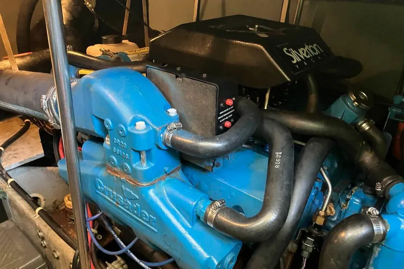 Slide: The Image of Engine of a 1994 Silverton 41 Aft Cabin yacht, featuring blue components and hoses. - 20