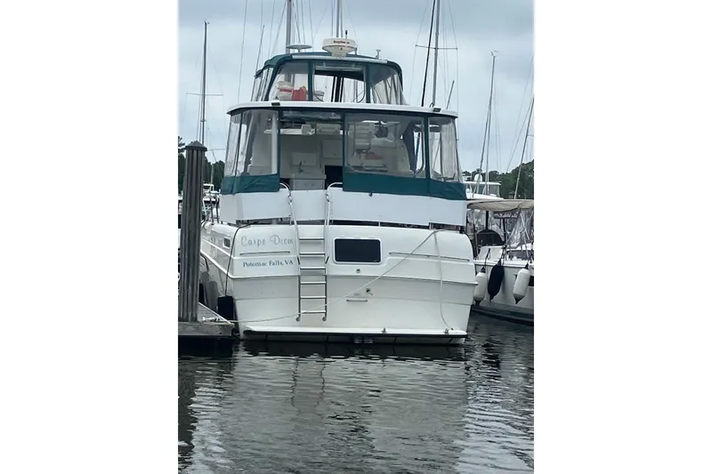 Slide: The Image of 1994 Silverton 41 Aft Cabin interior with sink, seating, and nautical decor. - 3