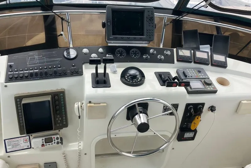 Slide: The Image of 1994 Silverton 41 Aft Cabin helm with dual seats and navigation equipment. - 5