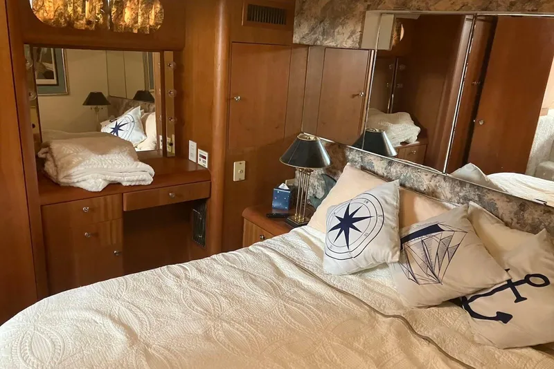 Slide: The Image of 1994 Silverton 41 Aft Cabin interior with TV, stairs, and seating area. - 7