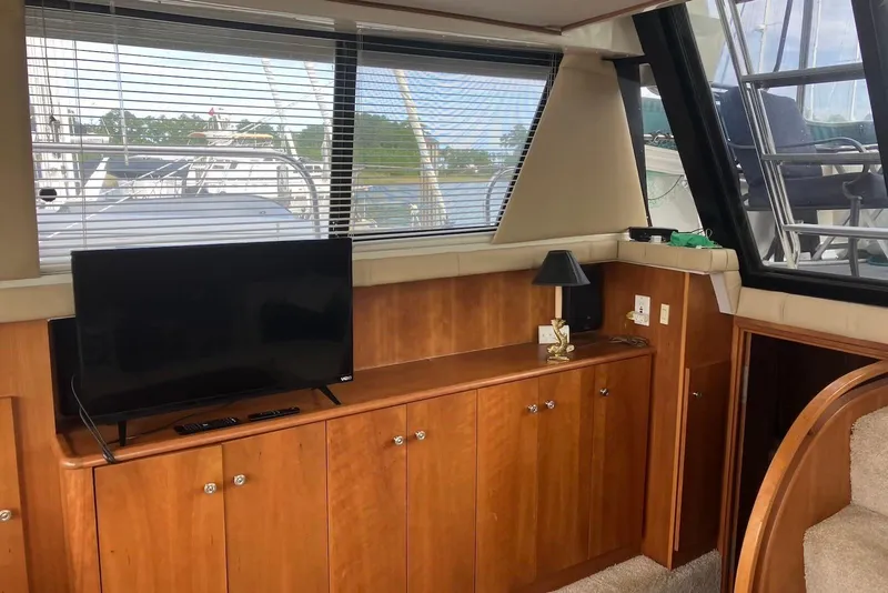 Slide: The Image of 1994 Silverton 41 Aft Cabin interior with cozy dining area and wooden accents. - 8