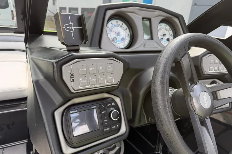 Slide: The Image of 2019 Axis A24 boat dashboard with steering wheel, controls, and gauges. - 14