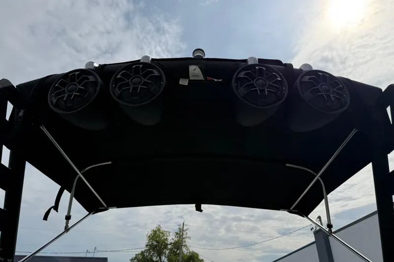 Slide: The Image of 2019 Axis A24 boat speakers on a wakeboard tower under a cloudy sky. - 22