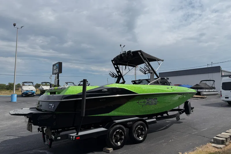Slide: The Image of 2019 Axis A24 boat in vibrant green on a trailer at a dealership. - 5
