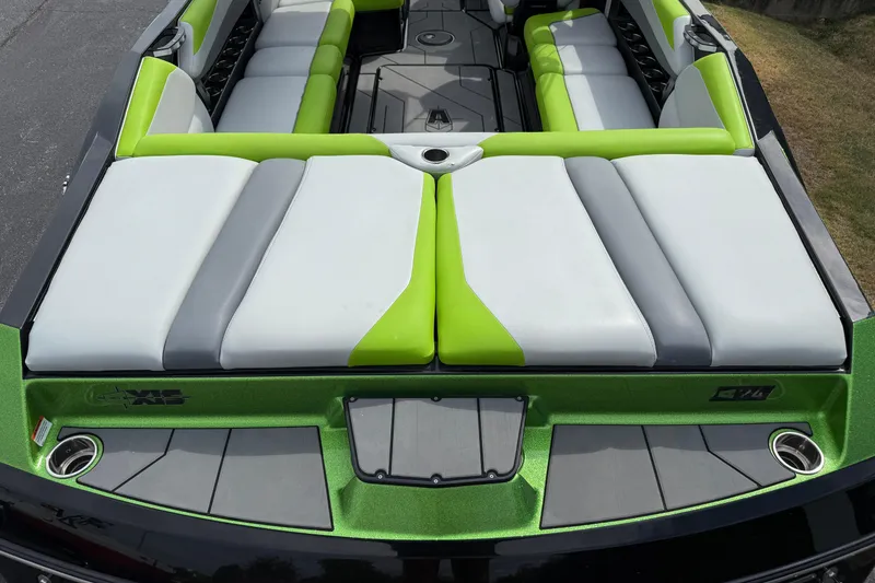 Slide: The Image of 2019 Axis A24 boat interior with green and gray seating, spacious layout. - 9
