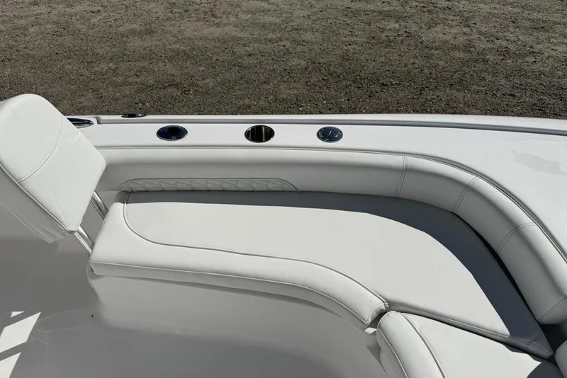 Slide: The Image of 2026 Tidewater 2500 Carolina Bay boat interior with white cushioned seating. - 10