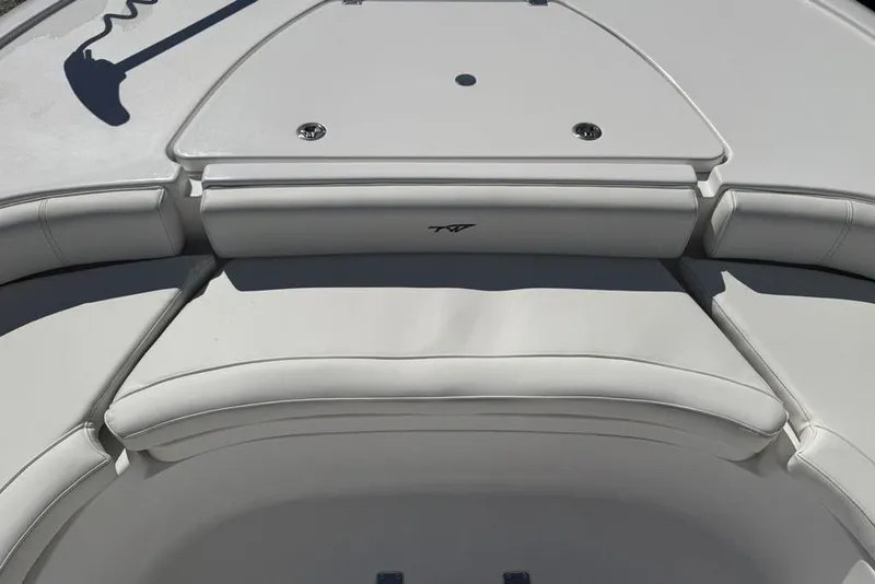 Slide: The Image of 2026 Tidewater 2500 Carolina Bay boat interior with cushioned seating and storage compartments. - 12
