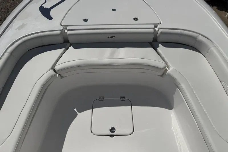 Slide: The Image of 2026 Tidewater 2500 Carolina Bay boat interior with cushioned seating and storage compartment. - 14