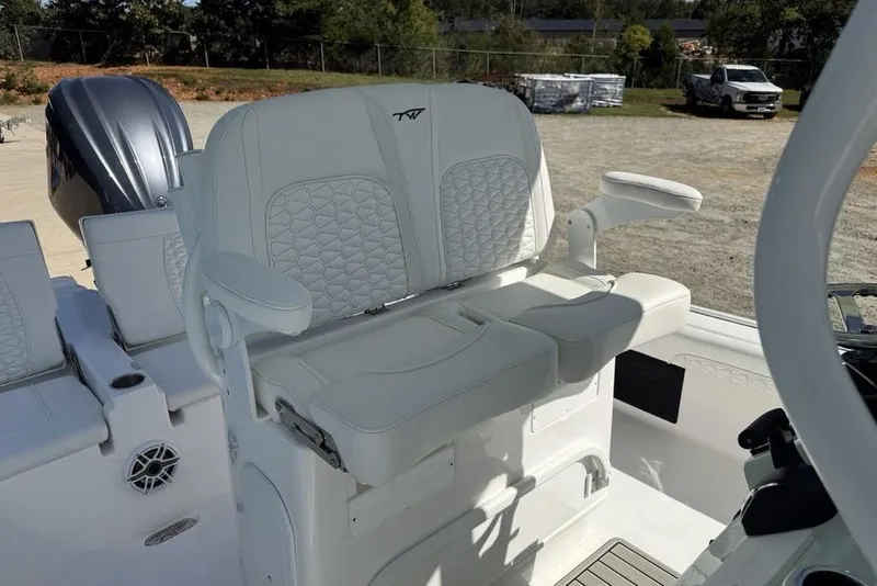 Slide: The Image of 2026 Tidewater 2500 Carolina Bay boat interior with white cushioned seating and armrests. - 18