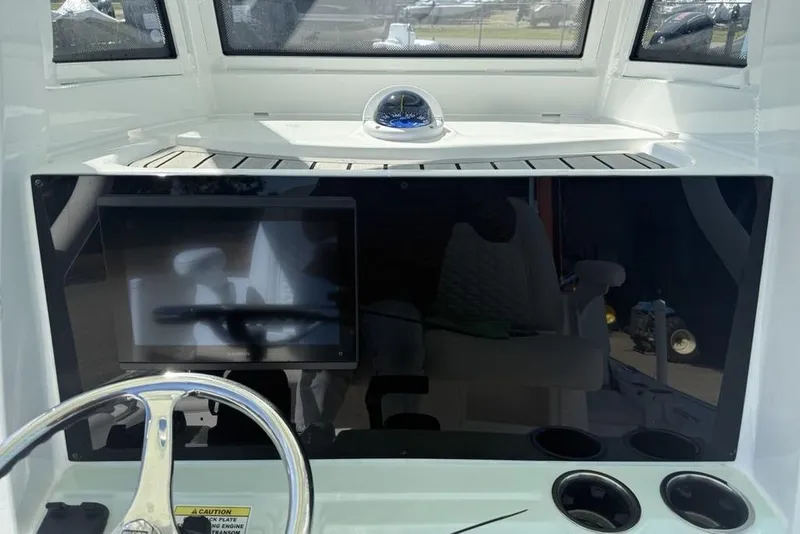 Slide: The Image of 2026 Tidewater 2500 Carolina Bay boat dashboard with steering wheel and touchscreen display. - 22