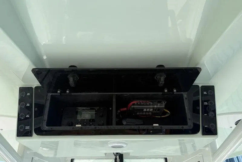 Slide: The Image of 2026 Tidewater 2500 Carolina Bay boat console with electronic equipment and controls. - 23